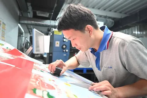 Printed packaging samples being reviewed before production