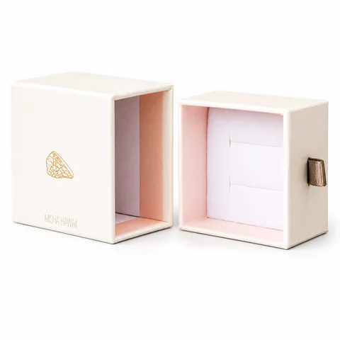 Cream jewelry drawer box opened to show its pink fitted interior
