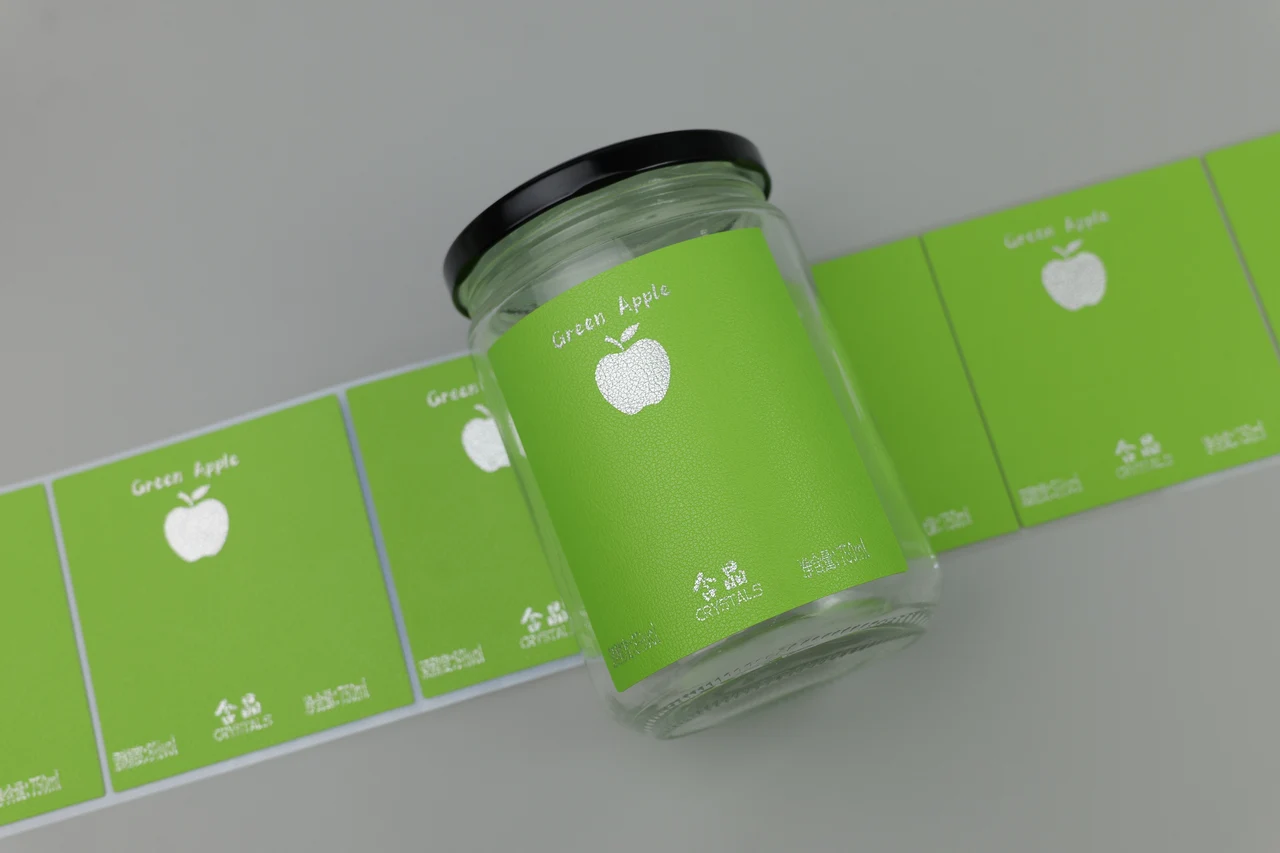 Green textured label applied to a glass jar beside matching printed labels