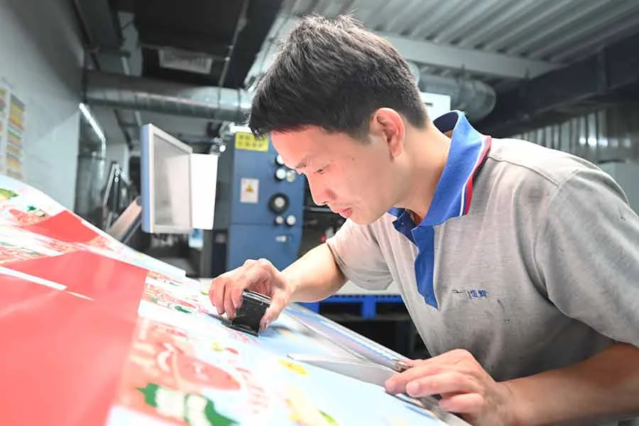Printed packaging samples being reviewed before production